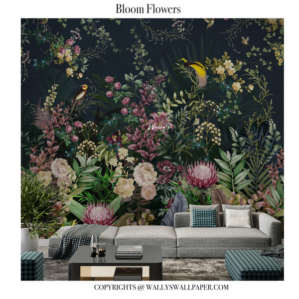 A large-scale botanical wallpaper mural featuring a dense arrangement of blooming flowers and birds on a dark navy background, styled in a modern living room setting behind a light gray sectional sofa.