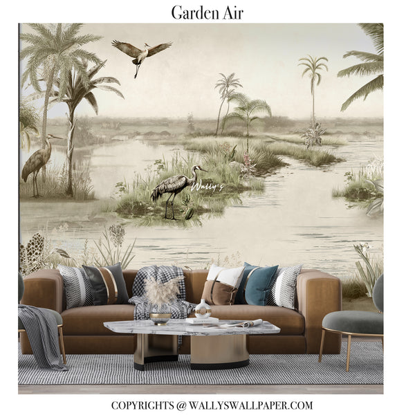 A large-scale wall mural featuring a serene wetland landscape with cranes, palm trees, and water, styled in a living room setting behind a brown leather sofa with decorative pillows.