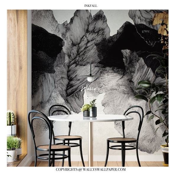 A dining room scene featuring a large black, white, and gray abstract mountain-style wall mural. A round white table with four black chairs is centered in front of the mural, with a hanging pendant light above.