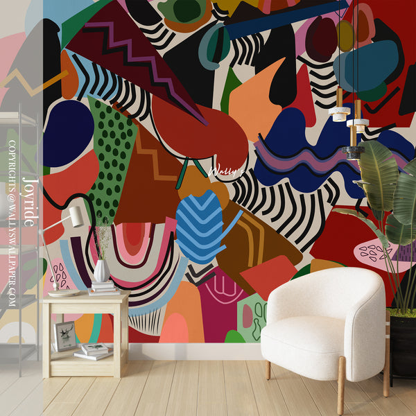 Colorful abstract wall mural in a room with a white chair and small table.