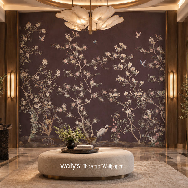 A large wall mural featuring an elegant Chinese-style floral and bird pattern in white and light blue on a dark plum background, installed in a luxurious interior setting with a round ottoman and warm lighting.