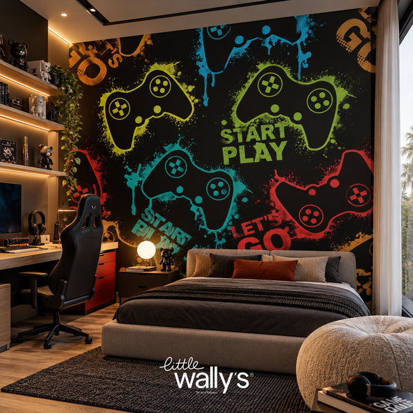 A modern bedroom featuring a large black gaming-themed wall mural with colorful controller silhouettes, neon-style text, and the words 'START PLAY' and 'LET'S GO'. The room includes a bed, desk, chair, shelving, and window.