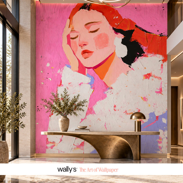 A large-scale wall mural featuring a stylized portrait of a woman in pink, red, white, and black, displayed in a modern interior lobby setting behind a metallic console table. The bottom of the image features a white banner with the text 'wallys The Art of Wallpaper'.