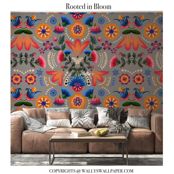 Rooted in Bloom floral wallpaper featuring bold hand-drawn flowers and rich ethnic patterns in red and earthy tones, shown as a rolled wallpaper.”