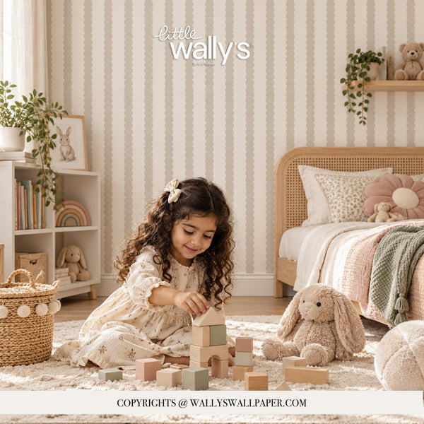 A young girl with curly brown hair sits on a white shag rug in a child's bedroom, playing with pastel wooden blocks. The room features vertical striped wallpaper in warm cream and beige tones, styled with a wooden bed, bunny plush toy, and shelves with toys and plants.