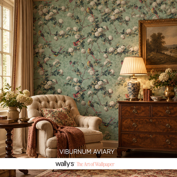 Styled living room with vintage bird-and-floral wallpaper, tufted armchair and wooden dresser.