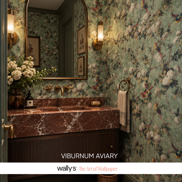 Bathroom with green floral bird wallpaper, dark wood vanity and brass fixtures.
