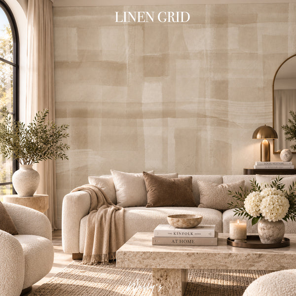 A styled living room featuring a large beige linen wall panel with a soft, textured brushstroke pattern. The room is styled with a cream sofa, neutral throw pillows, a marble coffee table, and decorative plants, with the text 'LINEN GRID' displayed at the top.